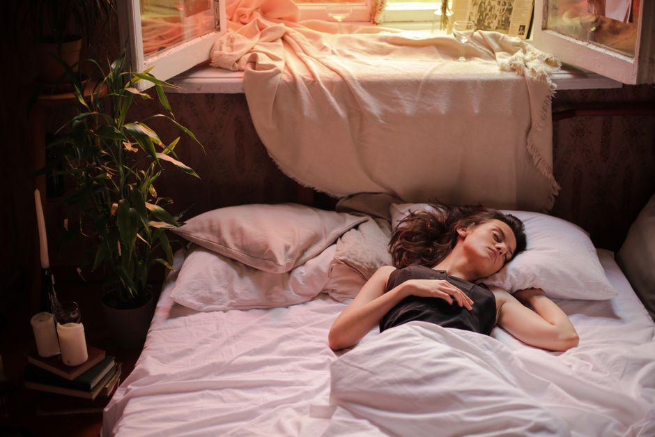 A side sleeper resting on a pillow in a softly lit bedroom